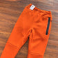 NIKE TECH FLEECE PANTS x CAMPFIRE ORANGE