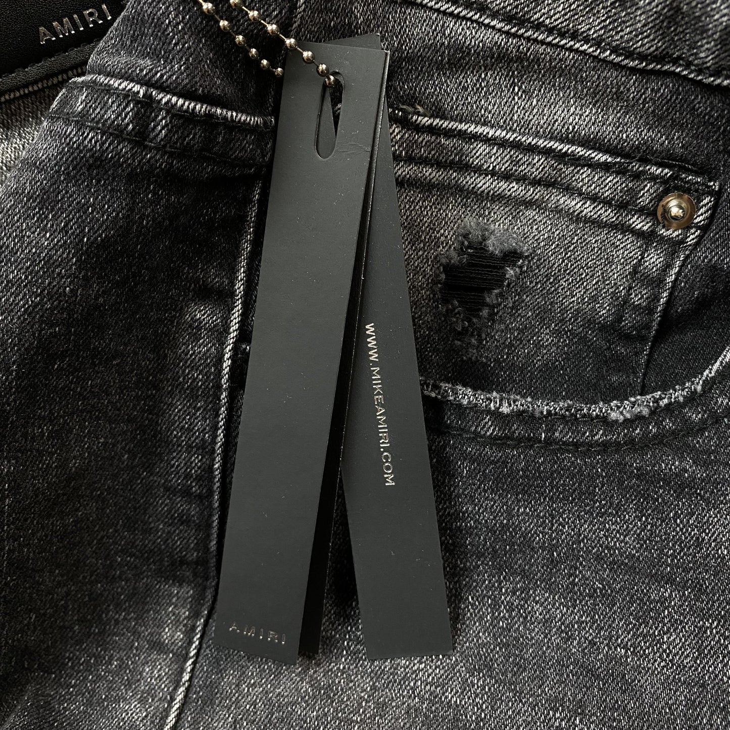 AMIRI VARSITY LOGO REPAIR JEANS